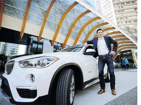 Modo's Sylvain Celaire stands with a BMW SUV last week. The co-op is introducing high-end vehicles to its fleet starting Monday.