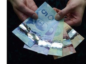 Polymer bank notes are shown during a news conference at the Bank of Canada in Ottawa on April 30, 2013. Prime Minister Justin Trudeau says the Bank of Canada is looking for a woman to be featured on a new bank note starting in 2018.