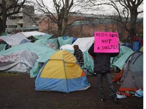 Residence of a homeless camp are shown in Victoria on Monday, January 11, 2016. Police in Victoria say they won't immediately enforce a Thursday deadline aimed at clearing residents from a tent encampment in the city's downtown core.THE CANADIAN PRESS/Chad Hipolito
