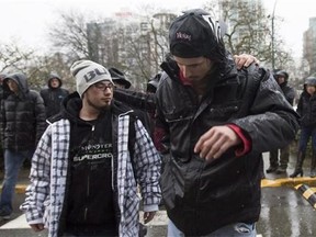 Saskatchewan men Charles Neil-Curley, left, and Jeremy Roy walk together as they arrive in Vancouver, B.C., Wednesday, March. 9, 2016. Neil-Curley and Roy both, homeless, were apparently given a one way bus ticket by the government of Saskatchewan.