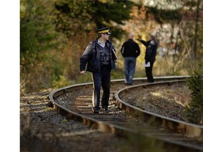 File photo: Police officers search for clues around the train tracks where Armstrong teen Taylor Van Diest, 18, was murdered Halloween night.