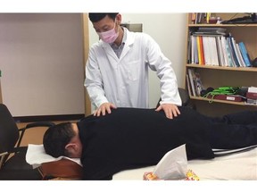 Traditional Chinese Medicine Practitioner treats a member of the First Nations.