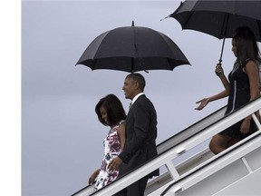 President Barack Obama, centre, and first lady Michelle Obama, visit la Catedral de La Habana in Havana, Cuba, Sunday, March 20, 2016. Obama's trip is a crowning moment in his and Cuban President Raul Castro's ambitious effort to restore normal relations between their countries.