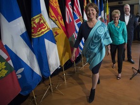 Ontario Premier Kathleen Wynne, centre, British Columbia Premier Christy Clark, left, and Quebec Premier Philippe Couillard leave after speaking to the media during a meeting of Premiers in Whitehorse, Y.T., Friday, July, 22, 2016.