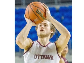 Ottawa Gee-Gees Michael L’Africain lines up a shot during the team’s practice prior to the CIS men´s basketball championship Final 8 tournament at the Doug Mitchell Thunderbird Sports Centre at the University of British Columbia in Vancouver Wednesday March 16, 2016.