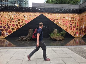 Passerby in front of Your Kingdom to Command by Marina Roy at Offsite, the Vancouver Art Gallery's public art site on West Georgia by the Shangri La Hotel. The work is on display to Oct. 10. Photo: Kevin Griffin