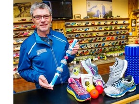 Paul Williams, holding an Addaday massage bar, displays running gear including some popular runners, sport watches and massage balls.