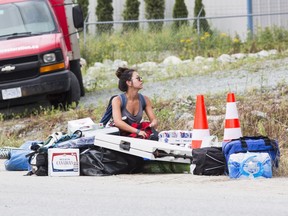 Kelsey O'Sullivan from California waits to load her camp gear into the Pemberton Music Festival on Thursday, July 14.