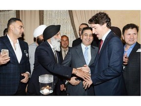 Prime Minister Justin Trudeau greets longtime Liberal organizer Prem Vinning at a Liberal fundraising event on March 1 in Surrey, hosted by former B.C. Liberal MLA Gulzar Cheema. The City of Surrey has hired Vinning to assist the city in acquiring provincial and federal funding.
