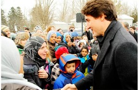 Prime Minister Justin Trudeau greets refugees in Peterborough, Ont., on Jan. 17. His government has announced an increase in the refugee and familiy reunification targets for this year, but a small increase in the target for economic migrants, such as skilled workers.