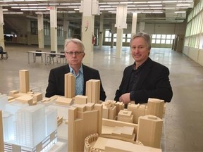 Project architects Mark Thompson and Mark Whitehead from Musson Cattell Mackey Partnership are shown in front of a model of the redeveloped old post office inside the current building at 349 West Georgia.