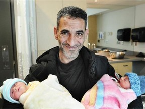 Recently arrived Syrian refugee Amjad Ktifan with his twin babies, Rinad and Mohammad at Surrey Memorial Hospital.