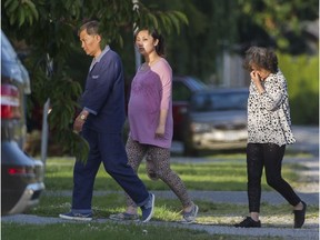 A possibly pregnant woman flanked by an older man and woman enter the property in the Blundell area of Richmond on June 30, 2016. A woman is petitioning Ottawa to stop birth tourism after watching what she believes is a birthing house for non-Canadian residents operating in her neighbourhood.