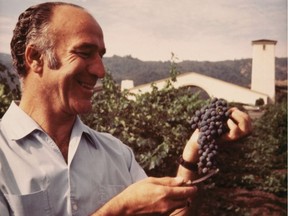 Robert Mondavi with a bunch of grapes, taken in the 1960s at Robert Mondavi Winery in Napa Valley.