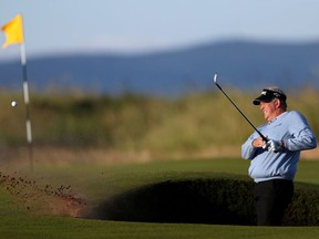 Scotland's Colin Montgomerie plays out of the bunker on the first hole during the opening round of the Open Golf Championship at the Royal Troon Golf Club in Troon, Scotland, on Thursday.
