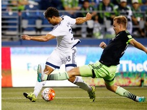 Seattle Sounders defender Chad Marshall (right) tries to stop a cross by Vancouver Whitecaps midfielder Kianz Froese during a CONCACAF Champions League soccer match last September in Seattle, where the teams will do battle again this weekend in MLS play.
