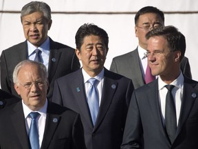 Japan's Prime Minister Shinzo Abe, center, poses for a group photo of with other Asian and European leaders at the 11th Asia-Europe Meeting (ASEM) in Ulaanbaatar, Mongolia, Saturday, July 16, 2016.