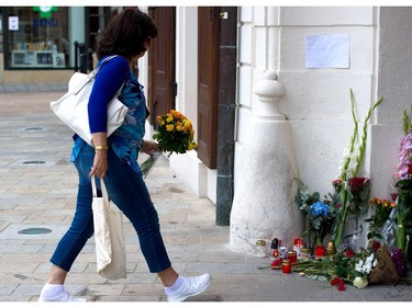 A woman brings flowers in front of the French embassy in Bratislava on July 15, 2016, to commemorate the victims of the deadly attacks in Nice. A man drove a truck into a crowd watching fireworks in the French Riviera city of Nice, killing at least 84 people.