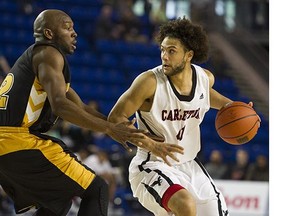 Carleton University Ravens #41 Kaza Kajami-Keane ( R ) wheels around  Dalhousie University Tigers #22 Kashrell Lawrence ( L ) in a semifinal A basketball game at the CIS Men's Basketball Final 8 National Championships at UBC, Vancouver March 19 2016.