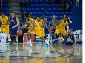 Ryerson University Rams players on the bench cheer on their teammates as they beat UBC Thunderbirds   in a session 1 basketball game at the CIS Men's Basketball Final 8 National Championships at UBC, Vancouver March 17 2016.