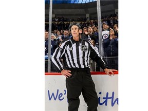 Linesman Brad Lazarowich looks on before leaving the ice as Winnipeg Jets fans give him a standing ovation for officiating his final NHL game between the Jets and the Minnesota Wild at the MTS Centre on April 3, 2016 in Winnipeg.