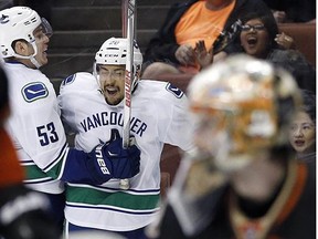 Vancouver Canucks right wing Emerson Etem (26) celebrates with center Bo Horvat (53) after scoring against the Anaheim Ducks during the third period of an NHL hockey game in Anaheim, Calif., Friday, April 1, 2016. The Canucks won 3-2. =
