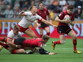 Wales' Chris Knight, right, runs for the winning try as Canada's Harry Jones, left, stretches but fails to reach him during World Rugby Sevens Series' Canada Sevens tournament action, in Vancouver, B.C., on Saturday March 12, 2016.