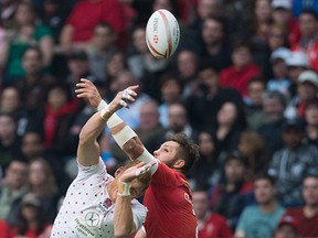 England's James Rodwell, left, and Canada's Admir Cejvanovic vie for the ball during World Rugby Sevens Series' Canada Sevens bowl semi-final action, in Vancouver, B.C., on Sunday March 13, 2016.