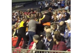 A Whitecaps fan was taken down by security after throwing popcorn at a player.