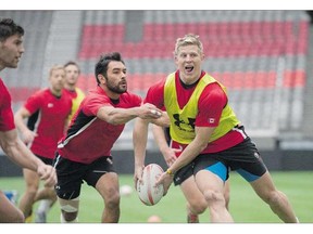 Team Canada captain John Moonlight is pursued by Phil Mack during a Tuesday practice at BC Place ahead of this weekend's World Sevens Series rugby tournament.