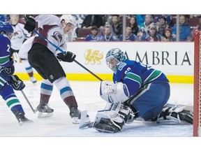 Vancouver Canucks goalie Ryan Miller stops the Colorado Avalanche's Nick Holden in close during the first period of an NHL game earlier this season at Rogers Arena. Miller will get the call again in net tonight to face the Avs.