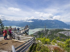 Tourists on the Panoroma Trail viewing platform at the Sea to Sky Gondola in Squamish.