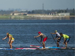 Participants make their way to the next buoy in the 5 km SUP race at the Champion of the Crescent festival at Surrey's Crescent Beach in support of the Surrey Hospital & Outpatient Centre Foundation Sunday.