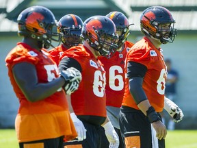 B.C. Lions centre Cody Husband, right, leads the offensive line during practice at their facility in Surrey on June 28. With five starters either new to the team or new to their deployment on the O-line, the unit has been a driver in the Lions’ surprising 3-1 start. Ric Ernst/PNG files