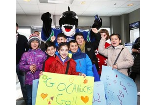The Syrian children clearly adore Fin as they gathered around the Canucks famous mascot for hugs.