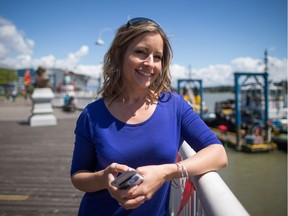 Tammy Meyers, Co-Founder and Chief Operating Officer of QuestUpon Technologies Inc., holds her iPhone as she stands for a photograph on the boardwalk at the Quay in New Westminster, B.C., on Thursday July 14, 2016. Meyers does a mental count every time she attends a business conference promoting the augmented reality company she co-founded. Virtually always, she's one of the only women in the room.