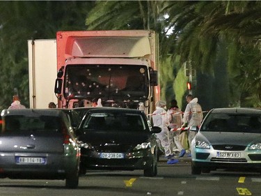 The truck which slammed into revelers late Thursday, July 14, is seen near the site of an attack in the French resort city of Nice, southern France, Friday, July 15, 2016. The truck loaded with weapons and hand grenades drove onto a sidewalk for more than a mile, plowing through Bastille Day revelers who'd gathered to watch fireworks in the French resort city of Nice late Thursday.