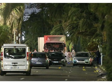 The truck which slammed into revelers late Thursday, July 14, is seen near the site of an attack in the French resort city of Nice, southern France, Friday, July 15, 2016. The truck loaded with weapons and hand grenades drove onto a sidewalk for more than a mile, plowing through Bastille Day revelers who'd gathered to watch fireworks in the French resort city of Nice late Thursday.
