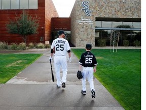 Then-Chicago White Sox player Adam LaRoche, left, and his son Drake walk to the clubhouse during a photo day before a baseball spring training workout in Phoenix in 2015.