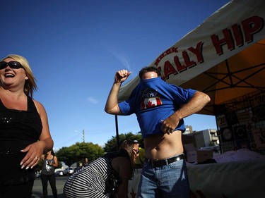 Fans buy t-shirts before the start of the Tragically Hip's Man Machine Poem Tour outside the Save-On-Foods Memorial Centre in Victoria, B.C., Friday, July 22, 2016.