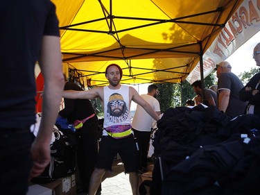 Fans buy t-shirts before the start of the Tragically Hip's Man Machine Poem Tour outside the Save-On-Foods Memorial Centre in Victoria, B.C., Friday, July 22, 2016.