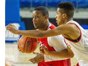 The University of Calgary Dinos’ Thomas Cooper (left) in action during the team’s practice on Wednesday, prior to the CIS men´s basketball championship Final 8 tournament that tips off Thursday, March 17, 2016 at the Doug Mitchell Thunderbird Sports Centre at the University of B.C.