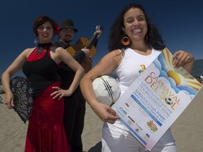 Paola Murillo, right, holds a poster during a promotional event for Carnaval Del Sol.