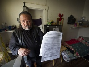 Jack Gates shows his eviction papers in his room at the Regent Hotel. He was awarded $1,675 by small-claims court after complaining about the lack of heat and hot water in his room. The owning company, Triville Enterprises, whose director is Parkash Sahota, has yet to pay.