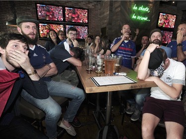Dejected French supporters watch as their team loses in extra time to Portugal in the 2016 UEFA European Championship between Portugal and France, at the Shark Club in Vancouver, BC., July 10, 2016.