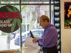 VANCOUVER, BC: July 12, 2016 -- Don Briere owner of Weeds Glass and Gifts on Richards Street in Vancouver, B.C. looks through some financial records for his national chain of cannabis retail outlets Thursday July 7, 2016.  (photo by Ric Ernst / PNG)  (Story by city)  TRAX #: 00044123C [PNG Merlin Archive]