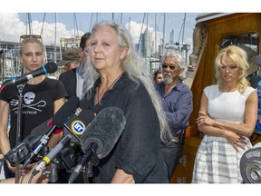 Canadian biologist Alexandra Morton speaks to the media aboard the Sea Shepherd Conservation Society's R/V Martin Sheen docked at Fisherman's Wharf in Vancouver. David Suzuki and Pamela Anderson listen in background.