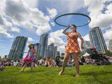 Darcy Riddell and her daughter Ruby hula-hoop to the music during Jazz fest weekend at David Lam Park in Vancouver, July 2, 2016.