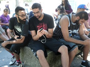 VANCOUVER, BC., July 24, 2016 -- Pokemon Go players, including Ryan Singh, Vincent and Michael Johal (l-r) congregate near the Art Gallery, in Vancouver, BC., July 24, 2016. (Nick Procaylo/PNG)   00044333A [PNG Merlin Archive]