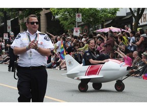 The Vancouver Pride Society has responded to demands that police be banned from marching in the city's annual Pride Parade with the suggestion that officers show up in fewer numbers and leave their uniforms at home. Participants in the 2016 Pride Parade in Vancouver.